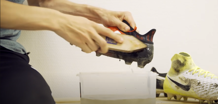 Person Cleaning Soccer Cleats